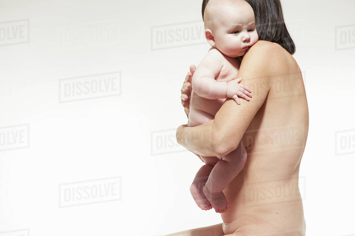 Naked Mother Comforting Naked Baby Resting Against Her Chest