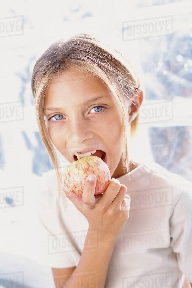 Girl eating apple Stock Photo Dissolve
