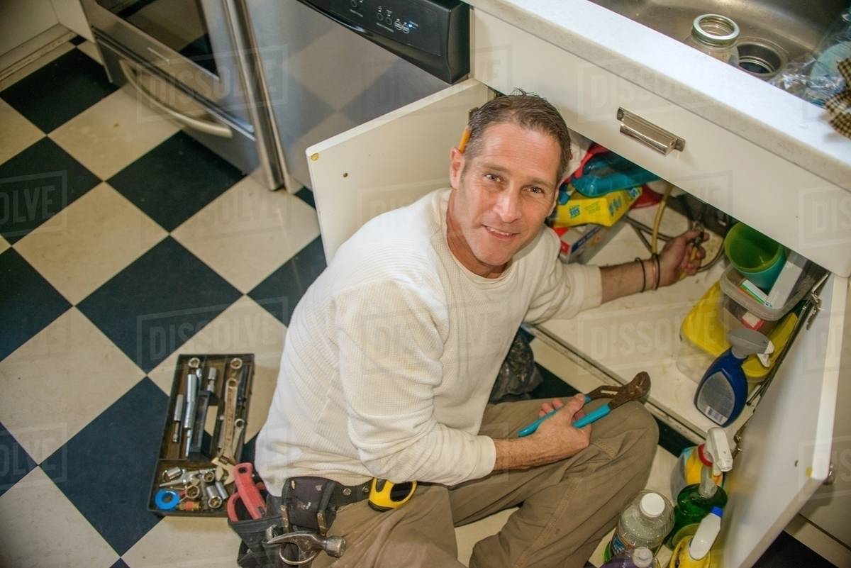 Handyman Fixing Kitchen Sink Pipe Stock Photo