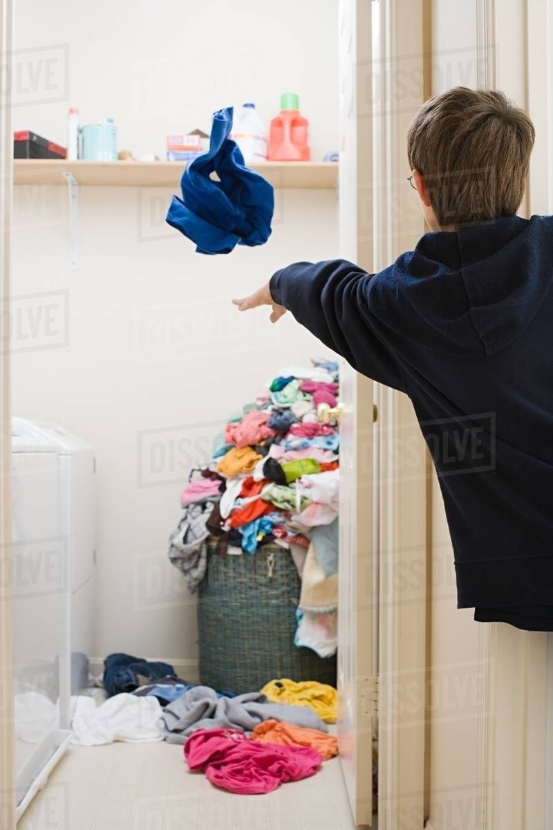 A boy throwing his laundry Stock Photo Dissolve