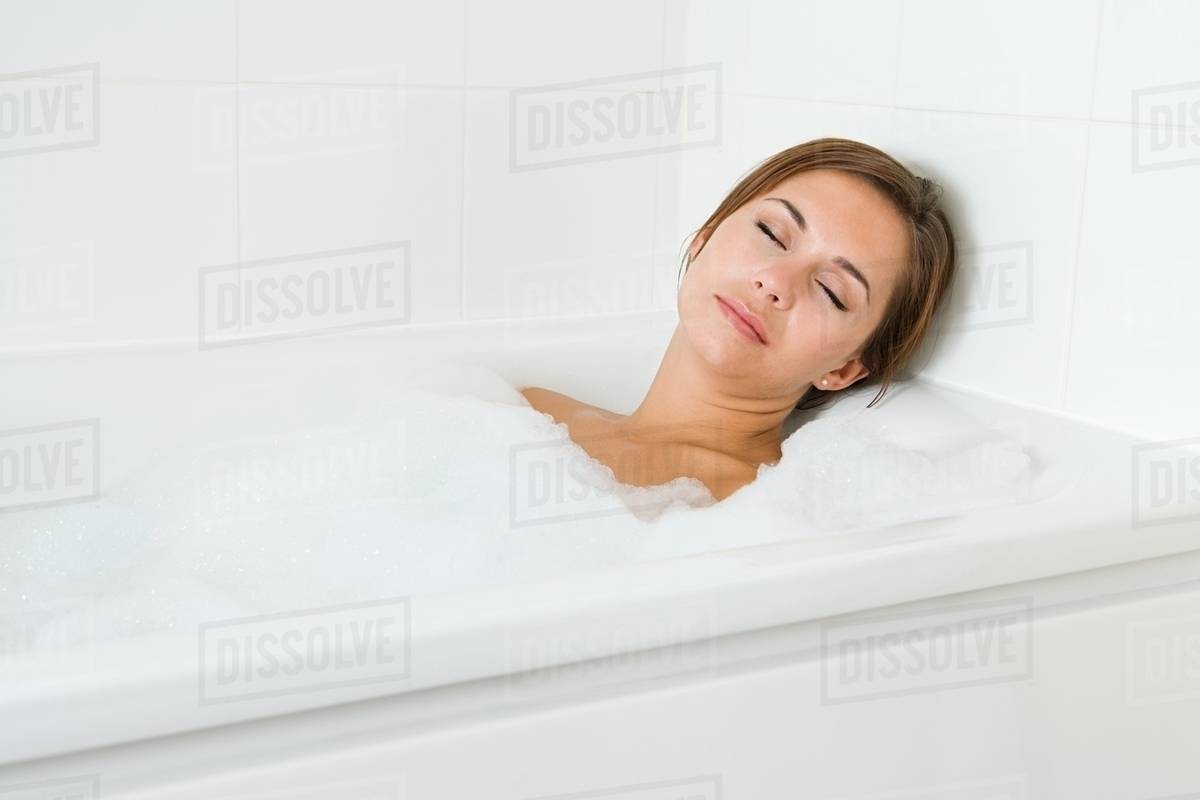 Woman sleeping in bath Stock Photo Dissolve