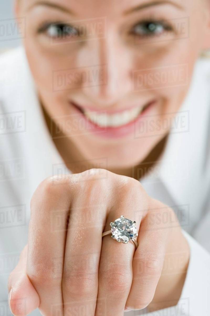 A woman wearing an engagement ring Stock Photo Dissolve