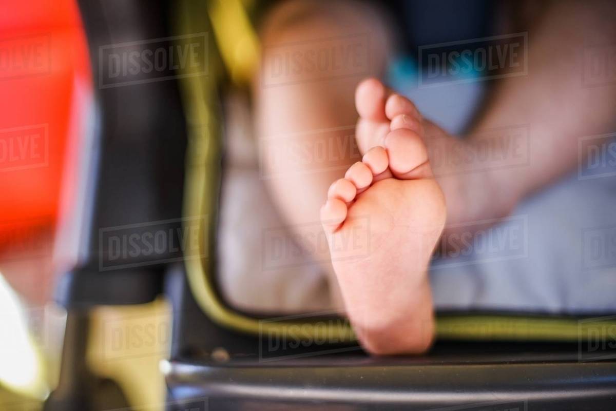 Close Up Of Baby Boys Feet Sitting In High Chair Close Up Of Baby Boys Feet Sitting In High Chair
