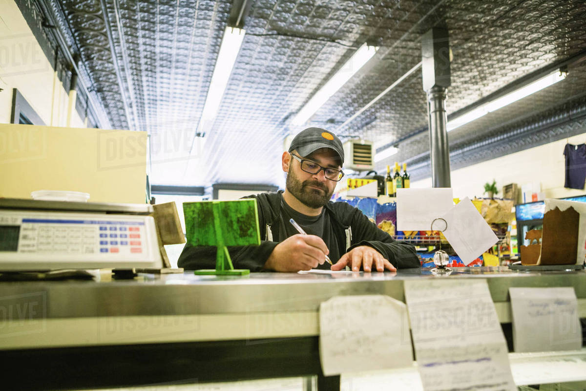 Customer in general store, Hague, USA Stock Photo Dissolve