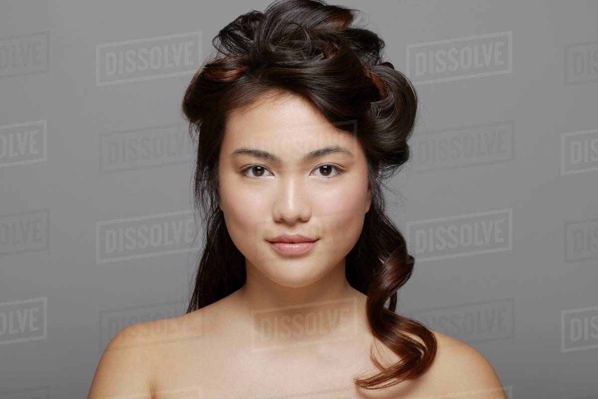 Head and shoulders shot of young woman bare shouldered Stock Photo