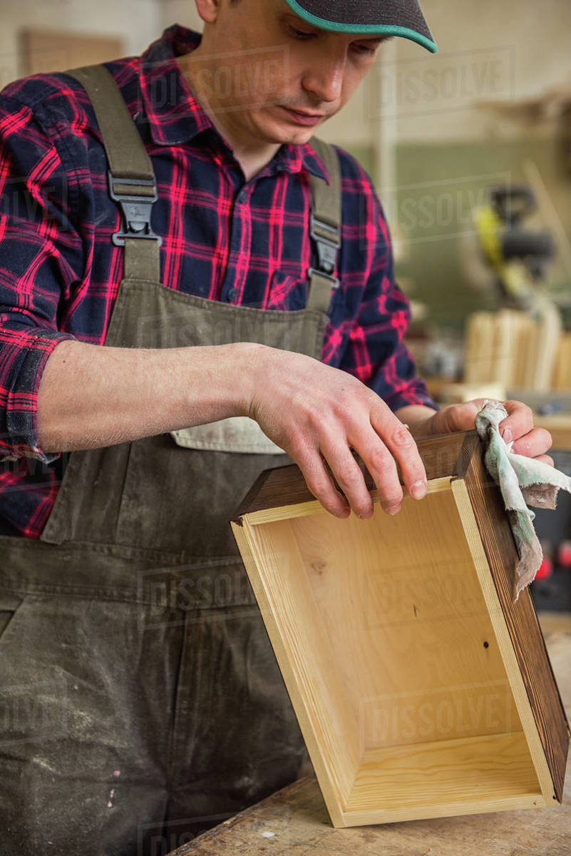 Carpenter painting wooden board in a wooden Profession, carpentry and woodwork concept
