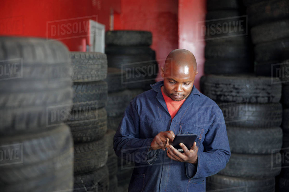 African man checking his smart phone on appointments for the day Royalty-free stock photo