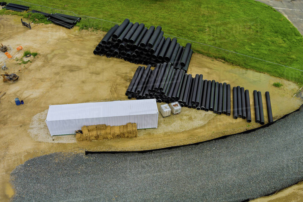 Plastic PVC pipes lying on the construction site ground on preparation for installation works