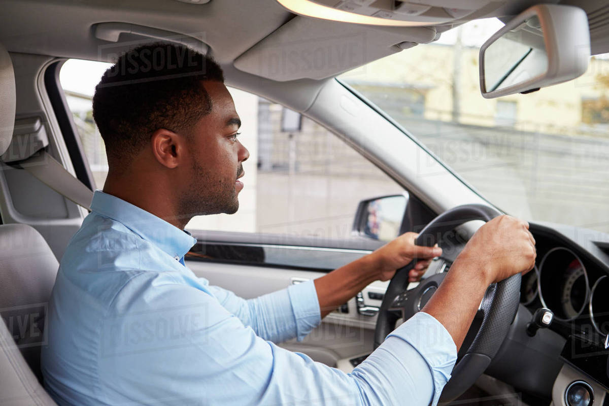 In car view of young male African American driving a car Stock Photo