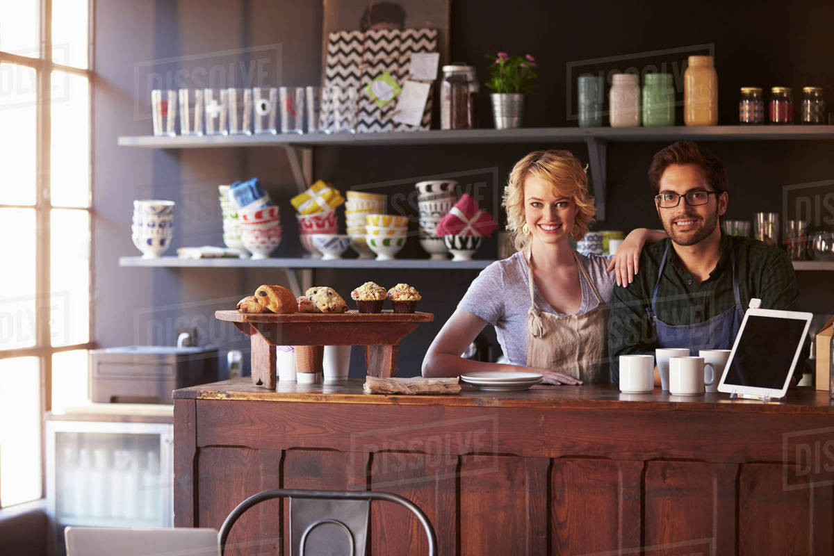 Portrait Of Couple Running Coffee Shop Behind Counter Stock Photo