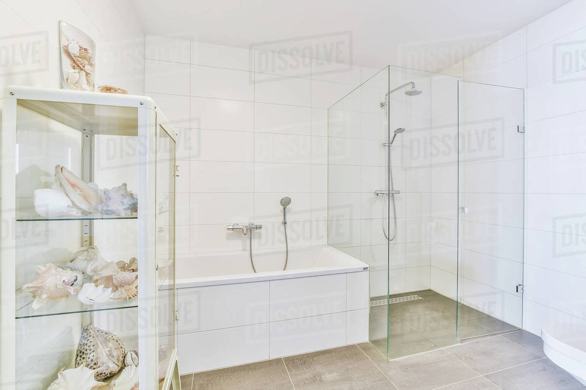 A stylish bathroom with a bathtub and shower cubicle Stock Photo