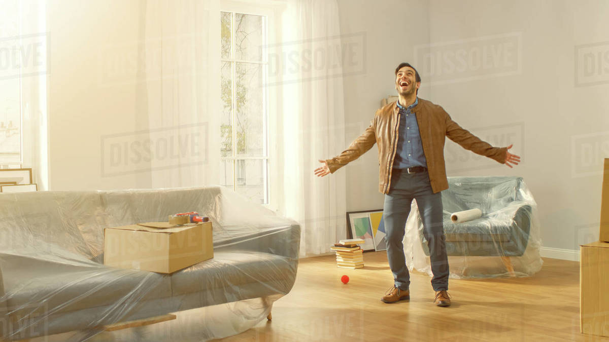 Shot of a very happy man moves into his new apartment and poses excited