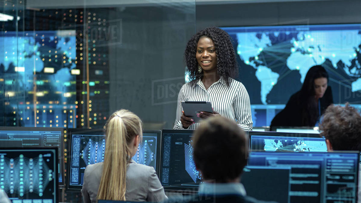 Chief Project Engineer Consults Tablet Computer and Holds Briefing for