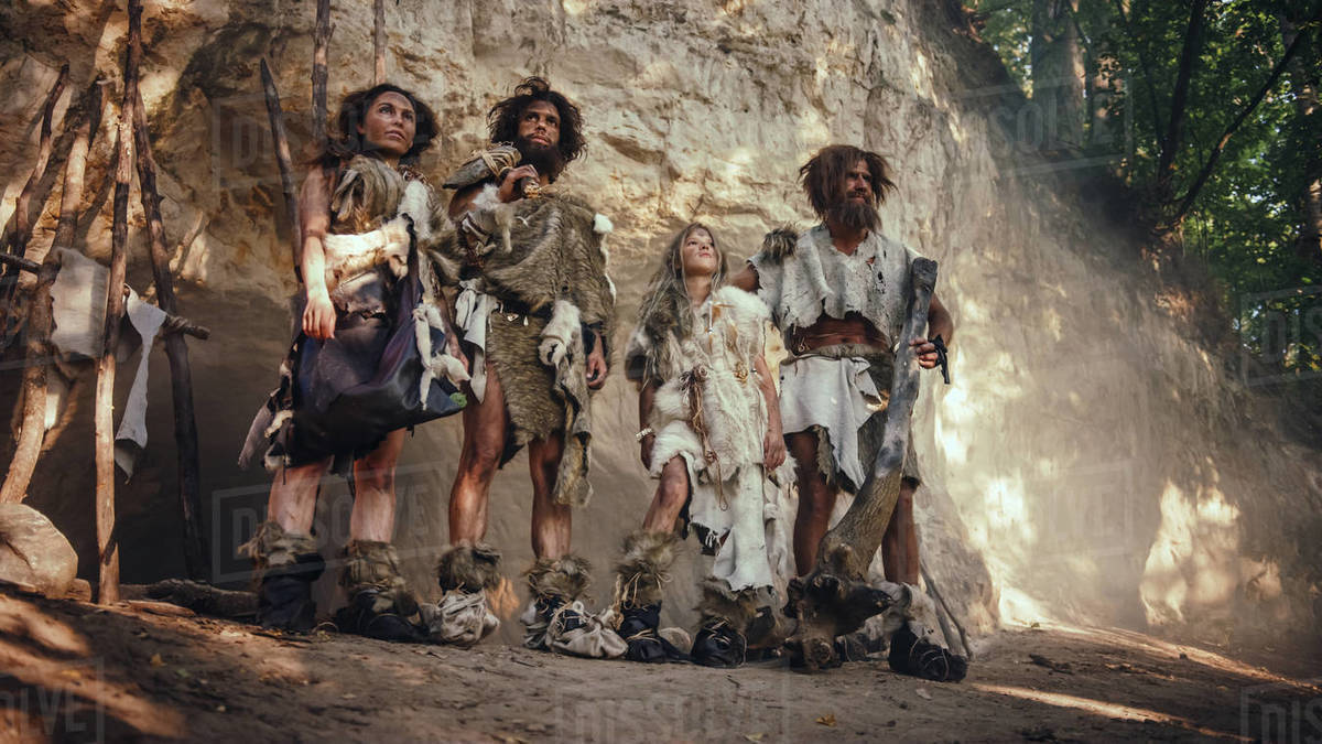 Tribe of Four HunterGatherers Wearing Animal Skin Holding Stone Tipped