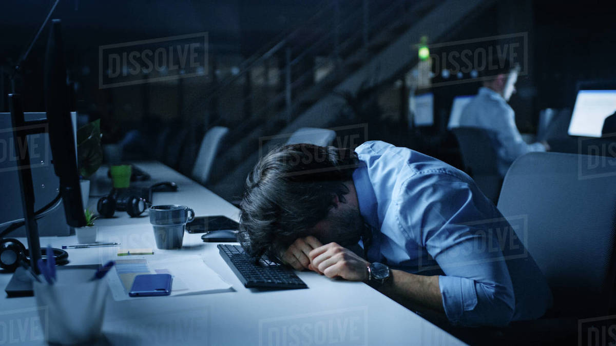 In the Office at Night Overworked Tired Office Worker Uses Desktop ...