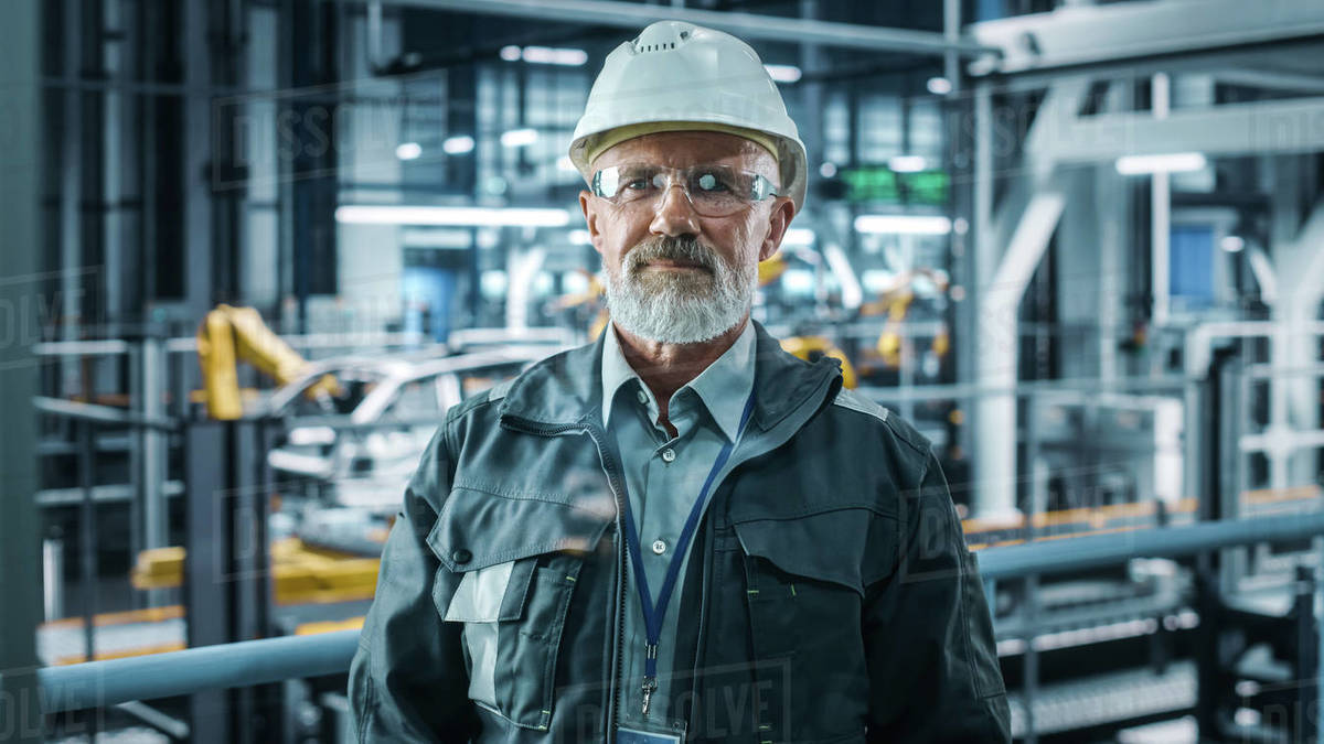 Portrait of Senior White Male Chief Engineer Looking at Camera and ...