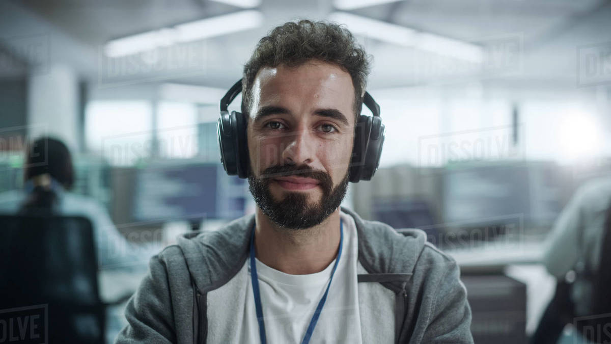 Office Portrait of Happy IT Programmer Wearing Headphones Working on