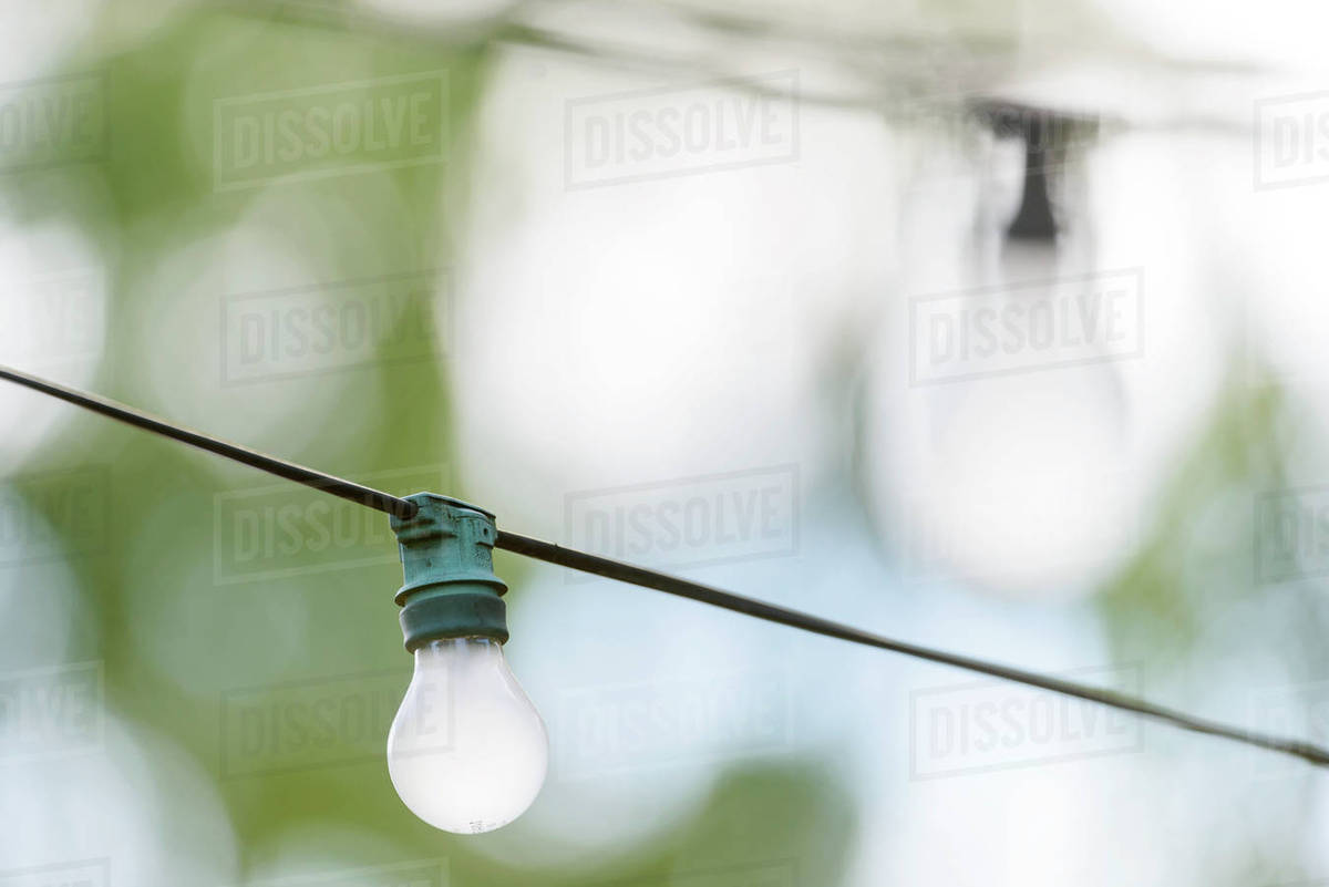 Light bulb on wire Stock Photo Dissolve