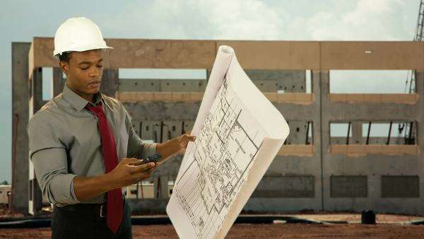 What It Takes To Be An Architect an architect holding a set of plans takes a call on his cell phone What It Takes To Be An Architect an architect holding a set of plans takes a call on his cell phone