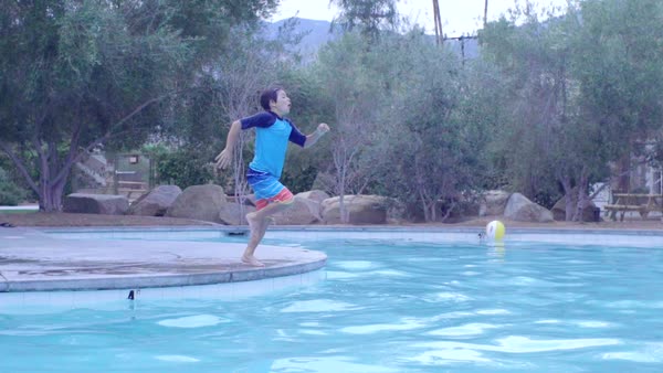 Swimming Pool Beach Ball Background slow motion shot of colorful beach ball and floating raft in a Swimming Pool Beach Ball Background slow motion shot of colorful beach ball and floating raft in a