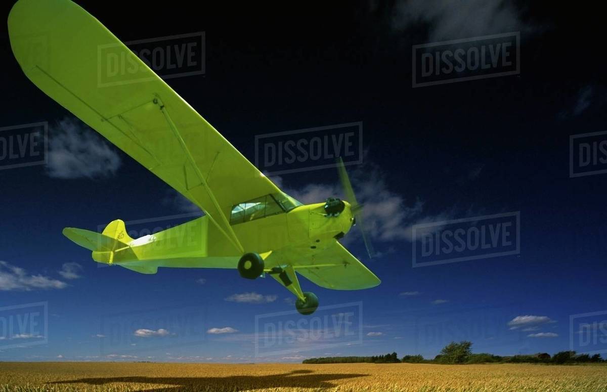 Airplane Flying Low Over Farmland Stock Photo Dissolve