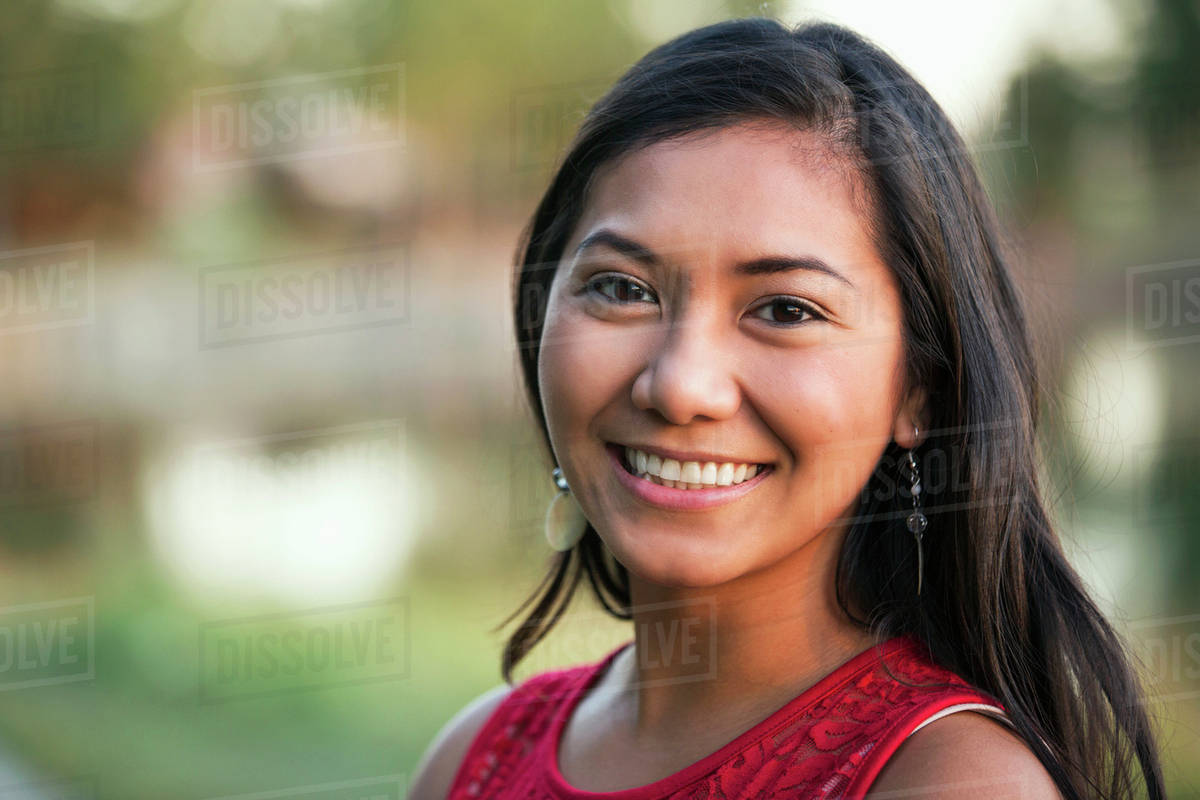 Portrait of a beautiful young Filipino woman smiling in a city park in