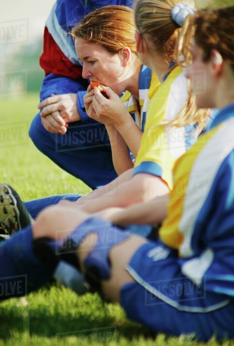 Soccer Players Sit On Grass Stock Photo Dissolve