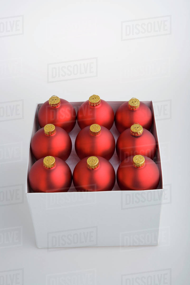 nine red christmas balls blurred in box on white background with green filter studio portrait - Red Christmas Balls nine red christmas balls blurred in box on white background with green filter studio portrait - Red Christmas Balls