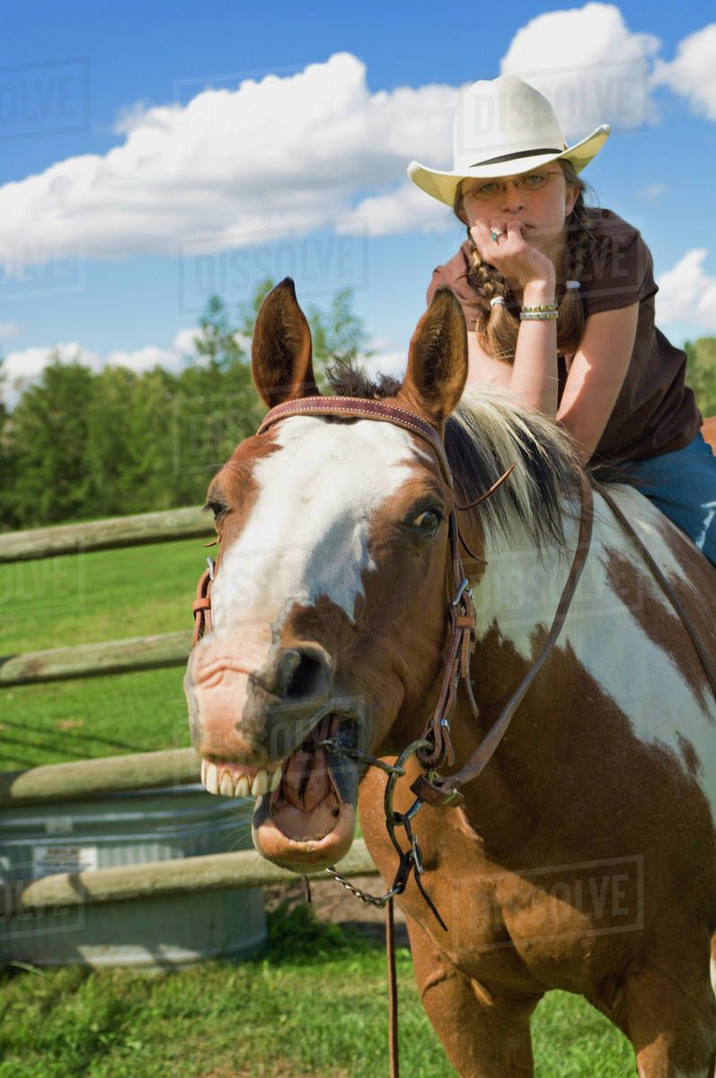 Horse Making A Funny Face While Being Ridden By A Young Cowgirl
