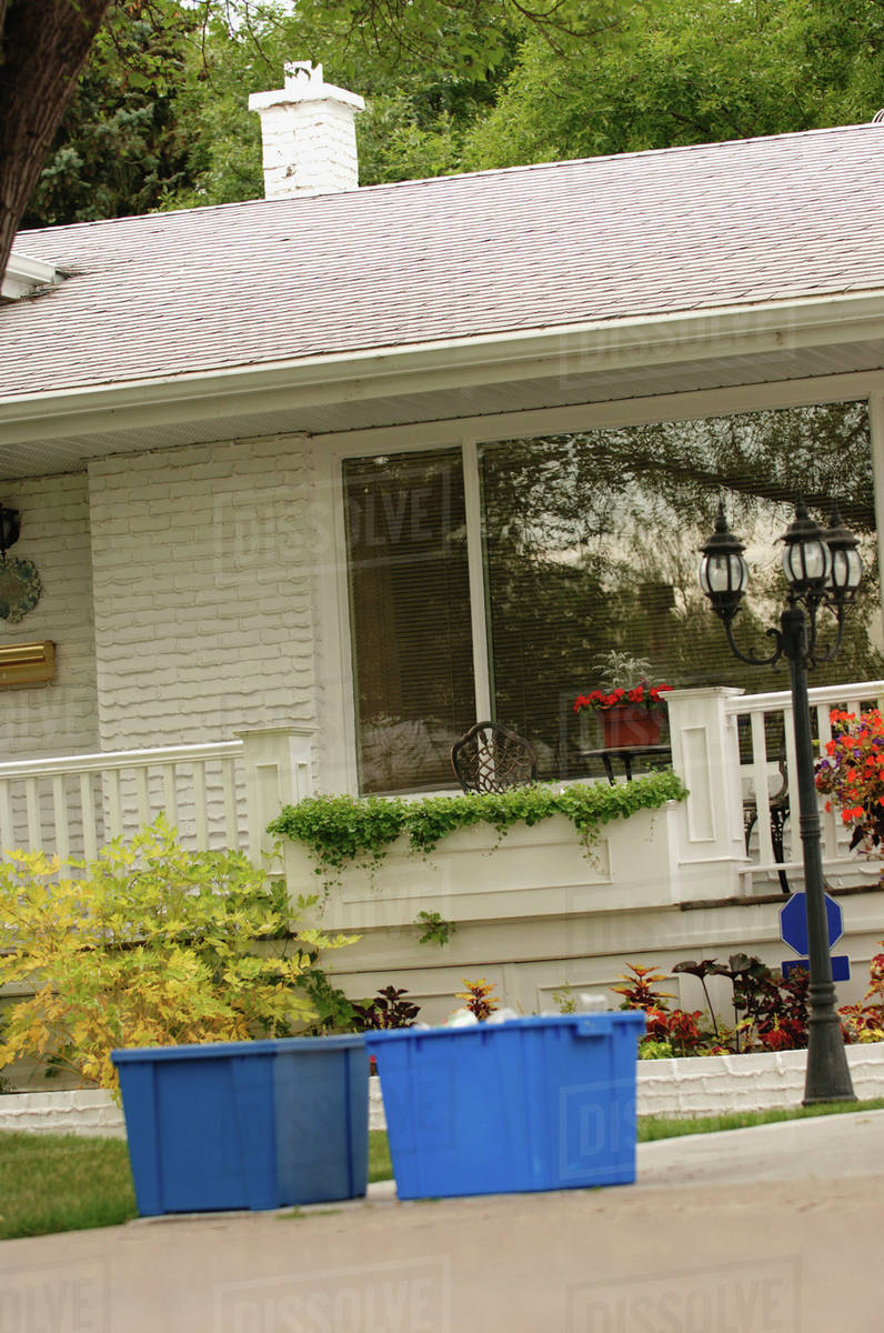 Blue Recycling Bins In Front Of House, Regina, Saskatchewan Stock