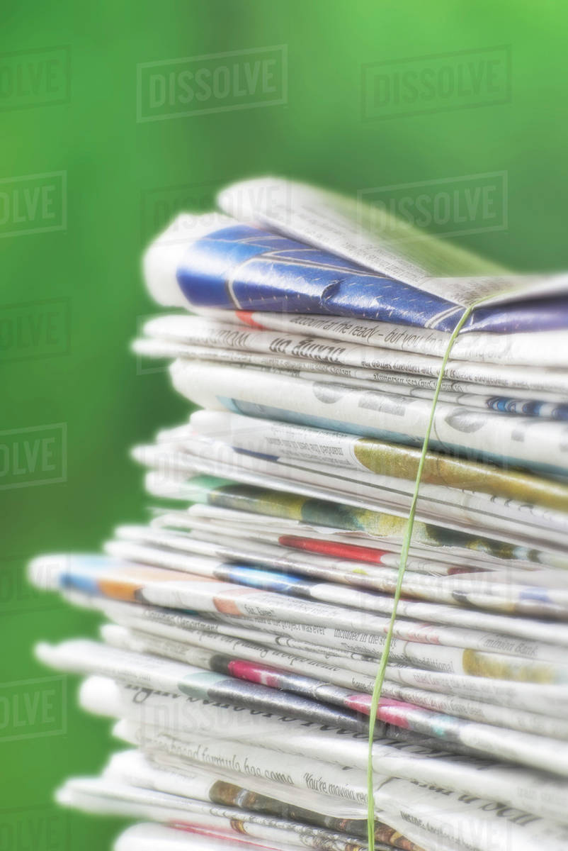 Newspapers Tied Into A Pile For The Recycle Bin. Stock Photo Dissolve