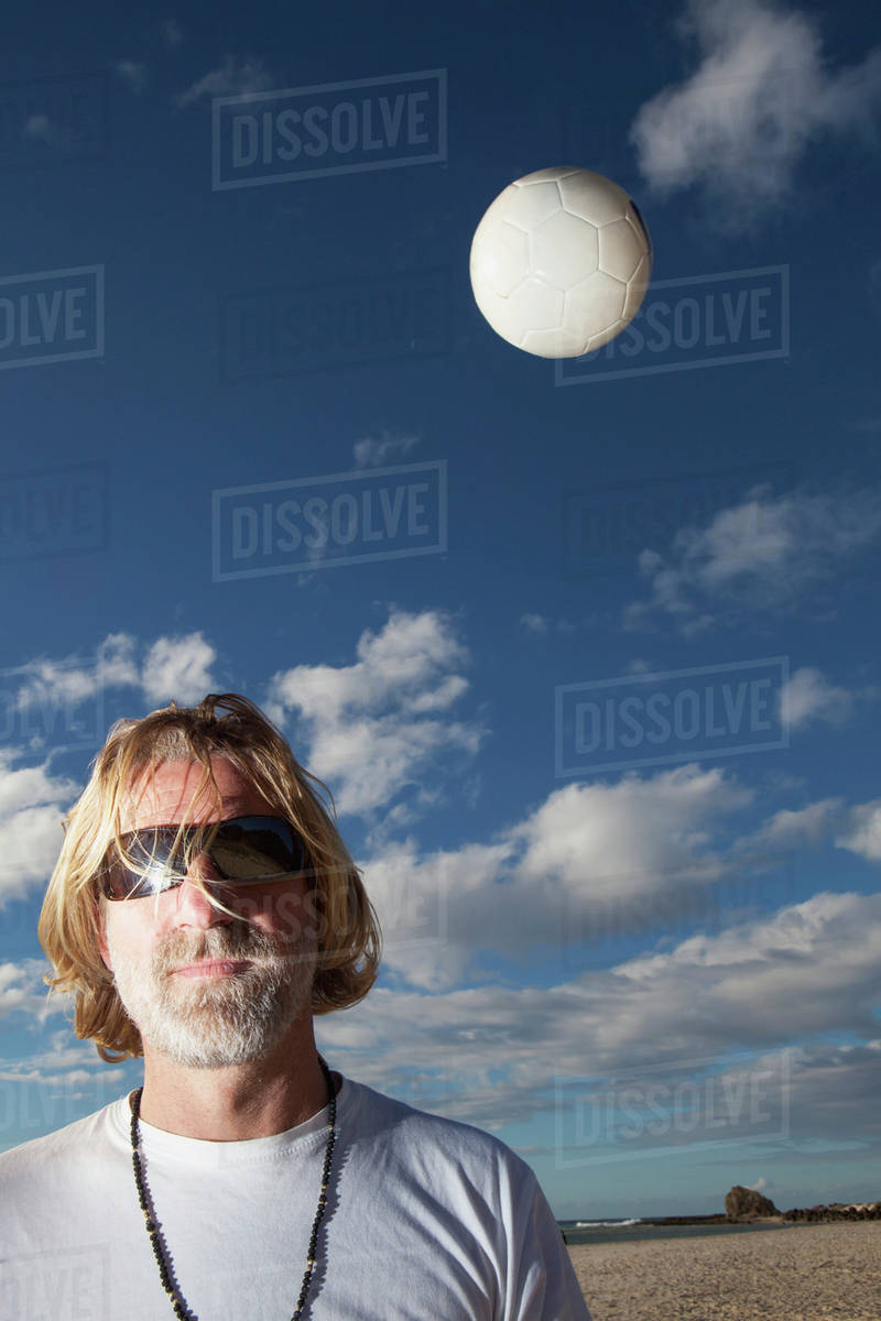 A man with sunglasses and a volleyball in the air;Gold coast queensland