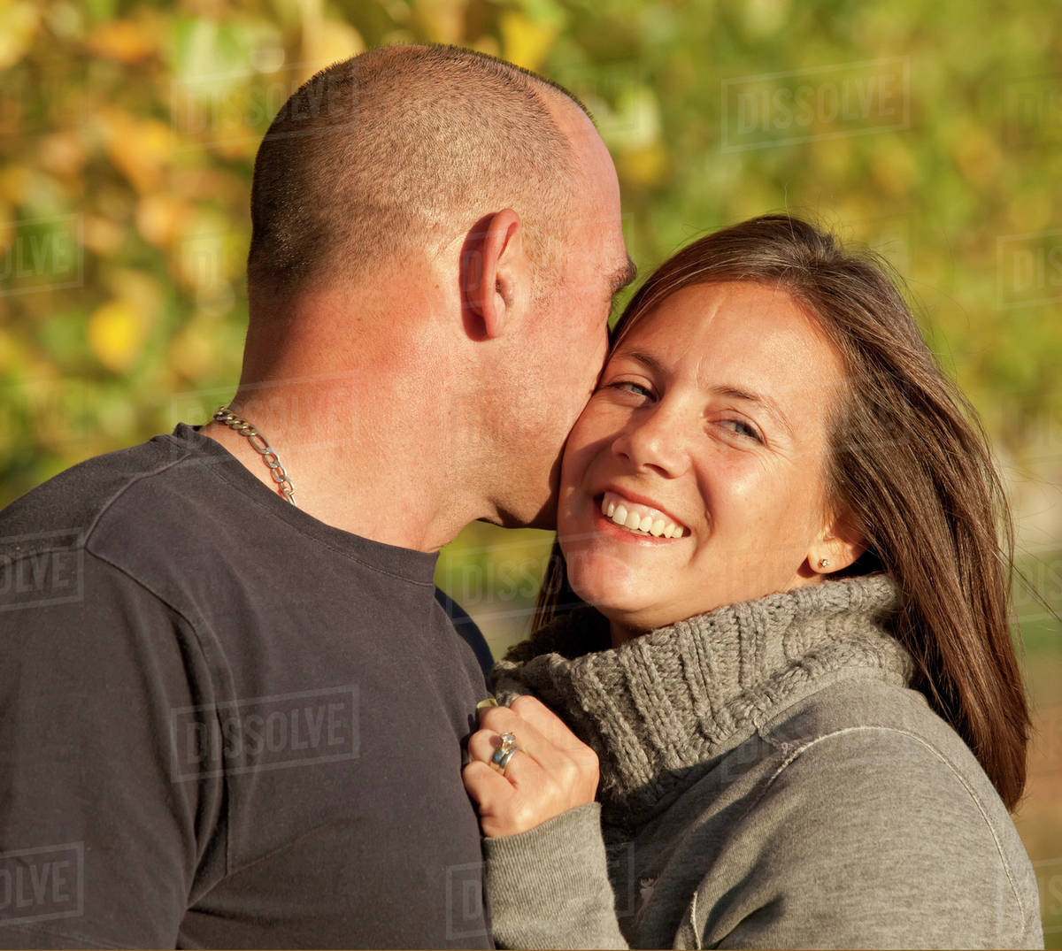 Portrait Of Husband And Wife Together In A Park; Beaumont, Alberta, Canada Stock Photo Dissolve