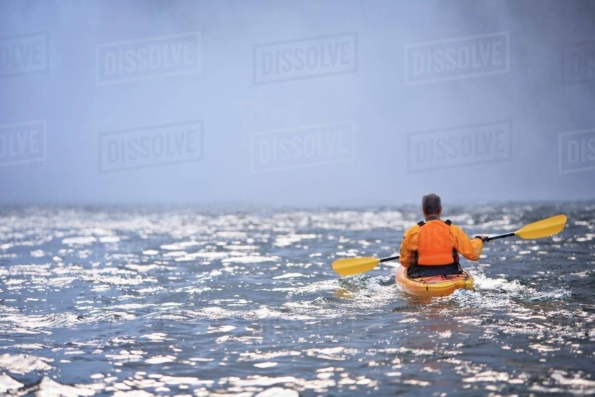 Washington, United States Of America; A Man Kayaking Near Snoqualmie