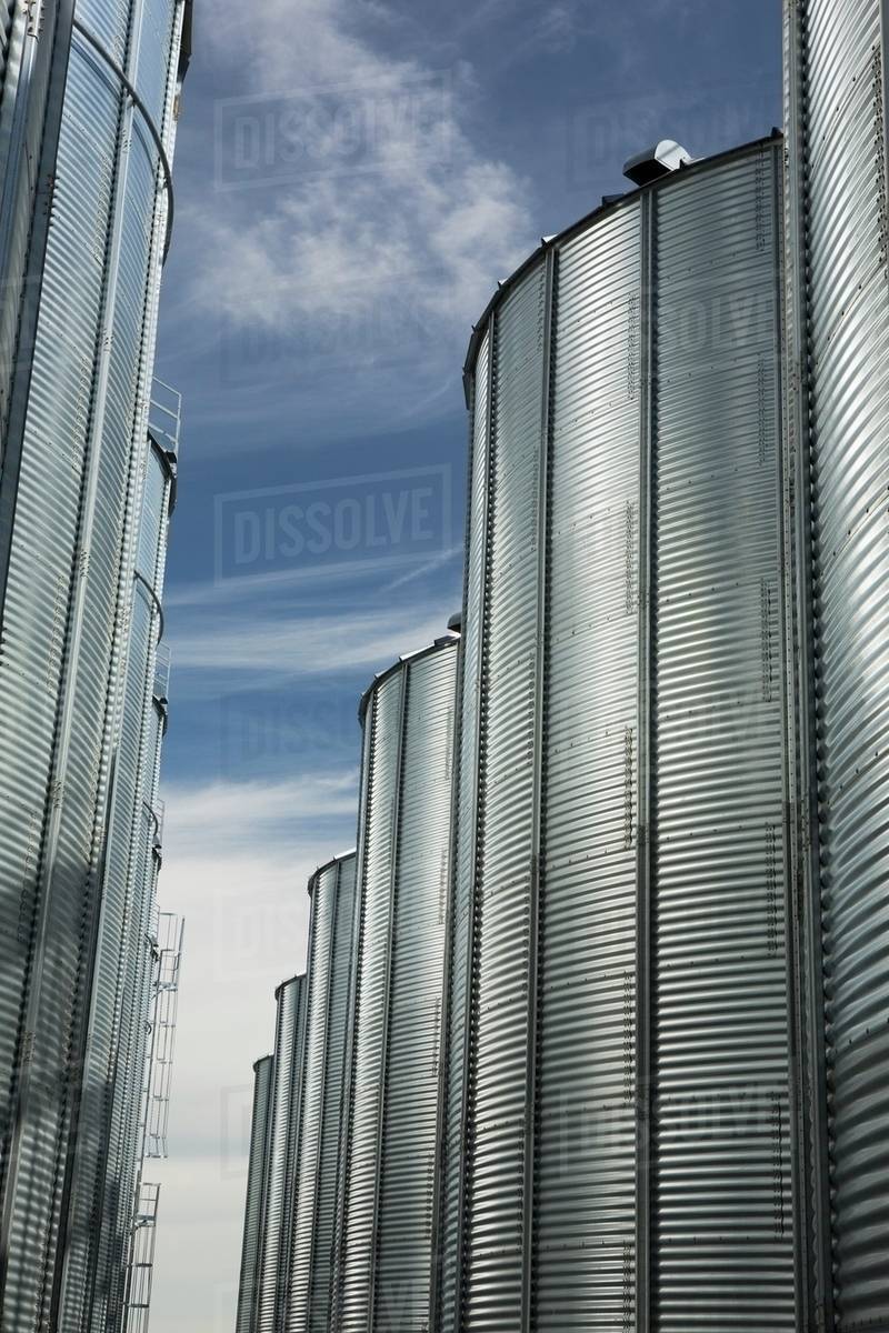 Large Grain Storage Bins; Alberta, Canada Stock Photo Dissolve