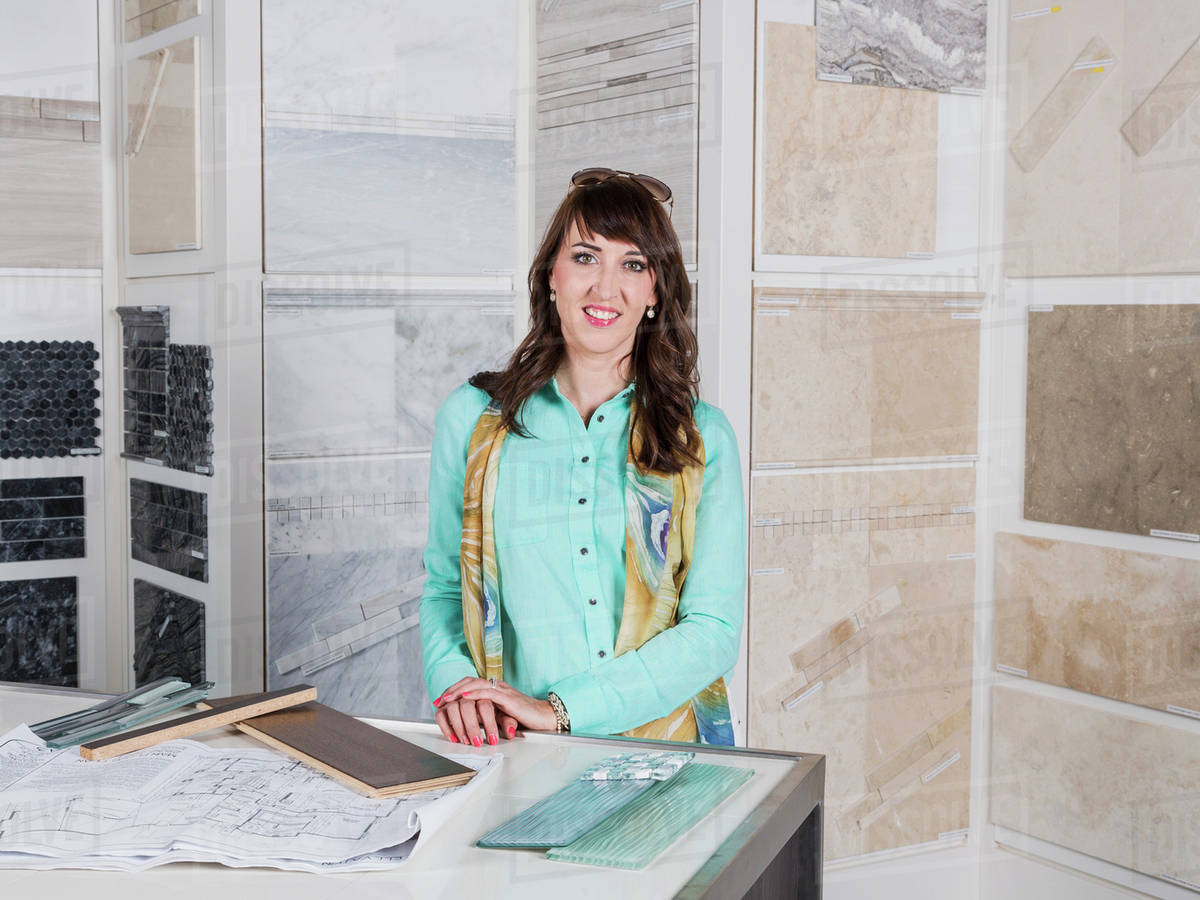 Interior designer selecting tiles in showroom of tile store; Edmonton, Alberta, Canada Stock