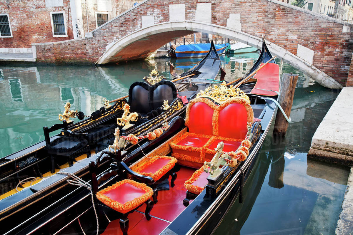 Gondolas in a canal; Venice, Italy Stock Photo Dissolve