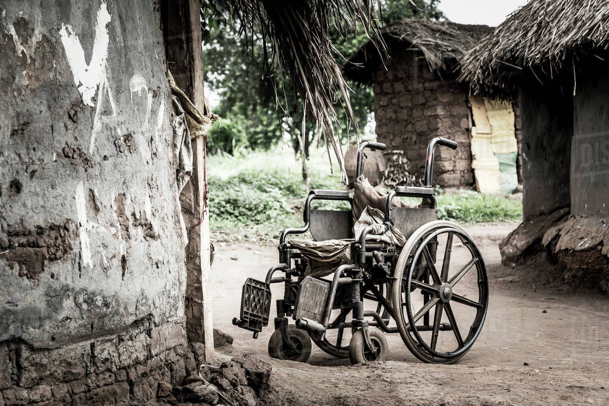 Wheelchair outside a house; Uganda Stock Photo Dissolve