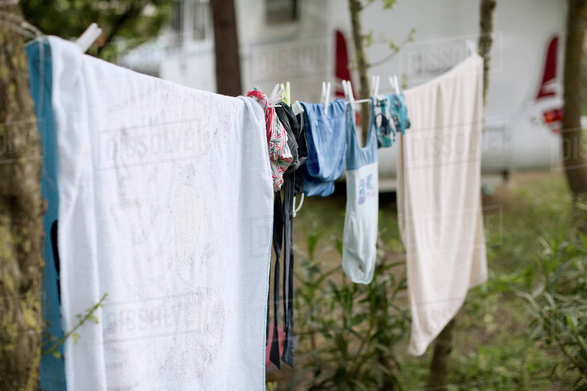 Clothes drying on clothesline at yard Stock Photo Dissolve