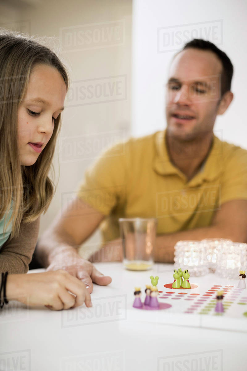Father And Daughter Playing Ludo At Coffee Table Stock Photo Father And Daughter Playing Ludo At Coffee Table