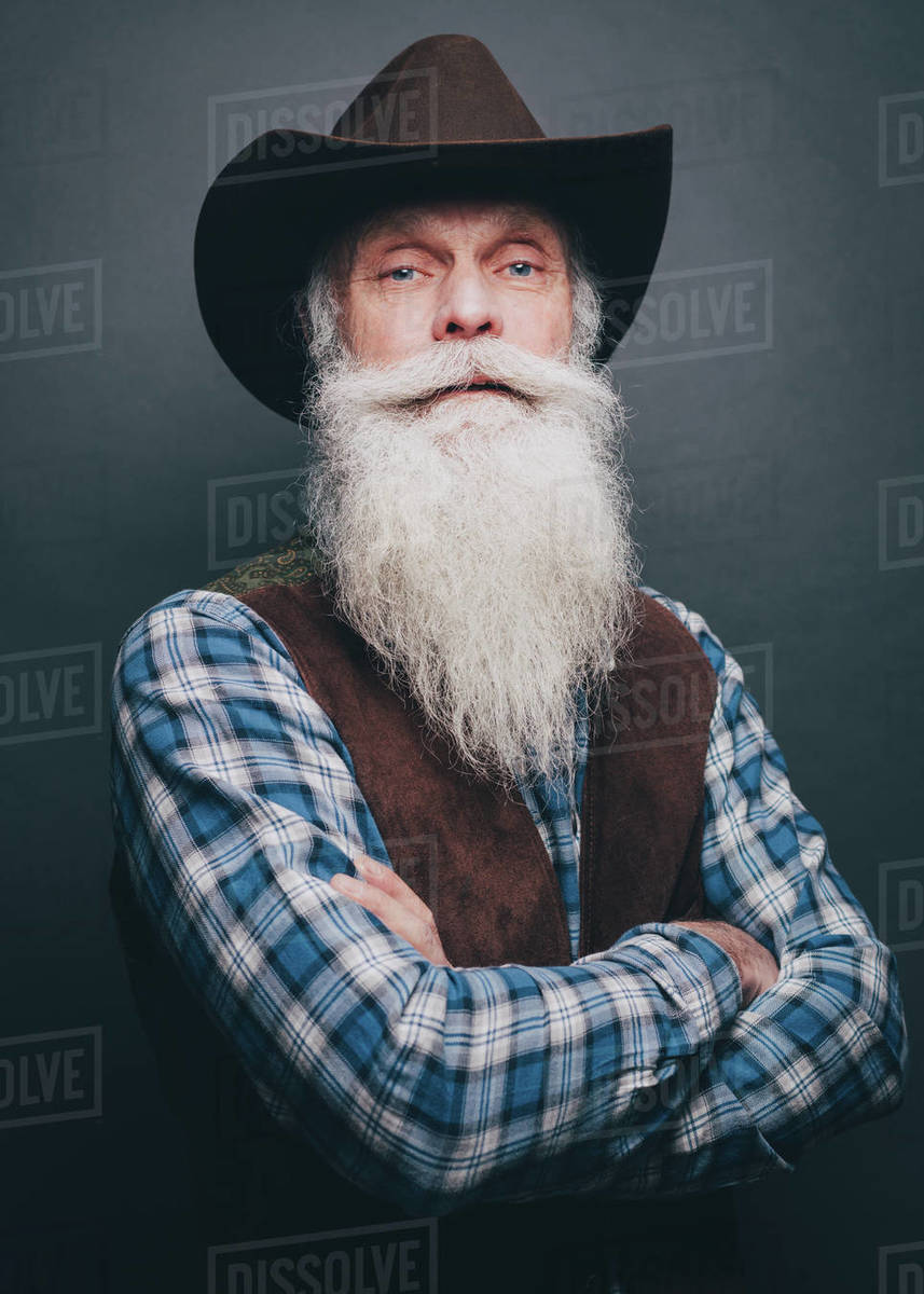 Bearded Senior Man Wearing Cowboy Hat Standing Arms Crossed