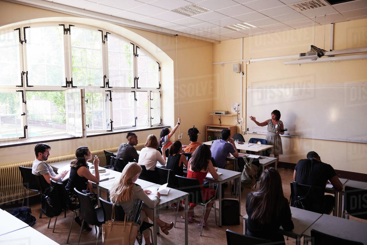 Female teacher asking questions to students in language school Royalty-free stock photo