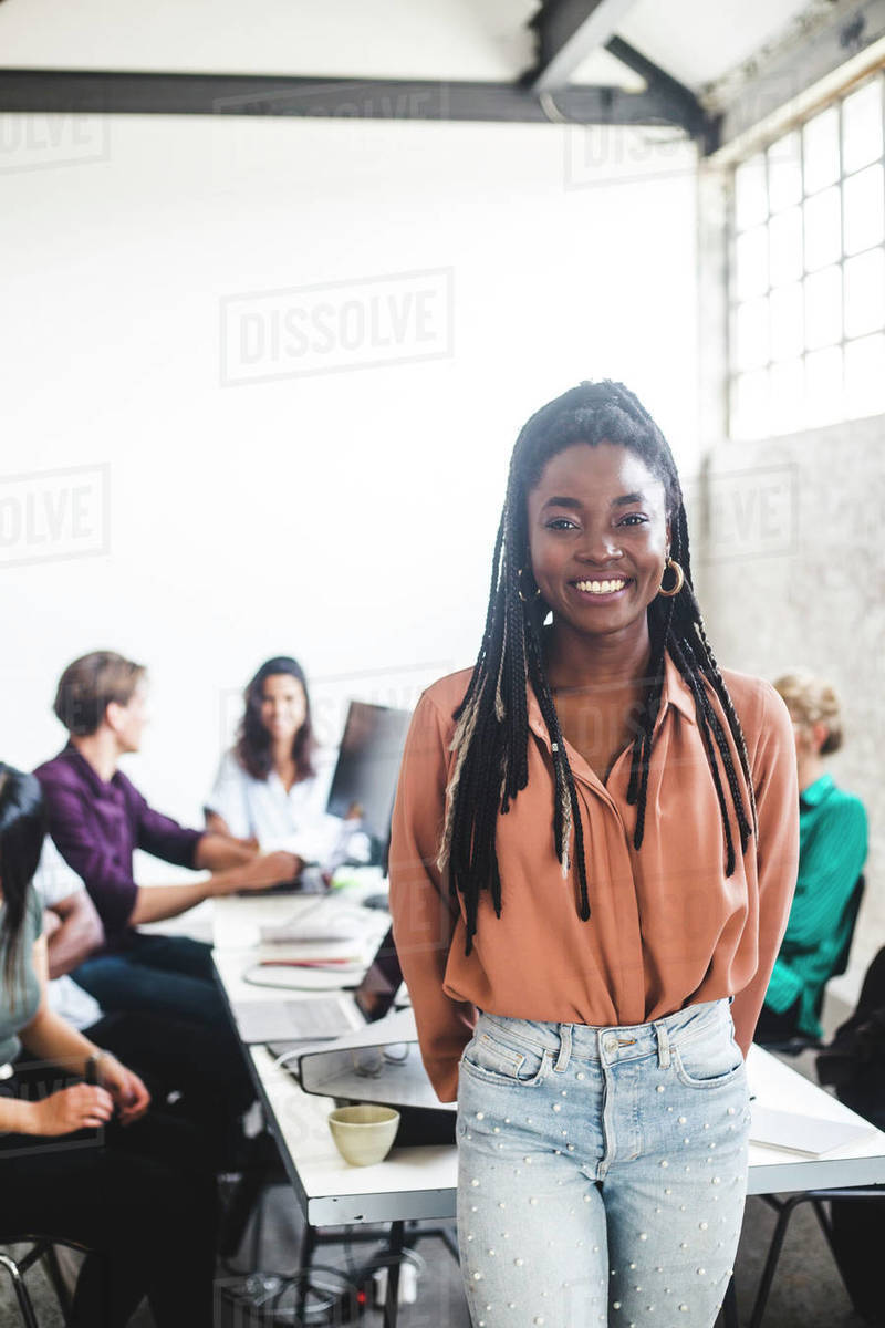 Cheerful young businesswoman working with IT programmers in board room at workplace Royalty-free stock photo