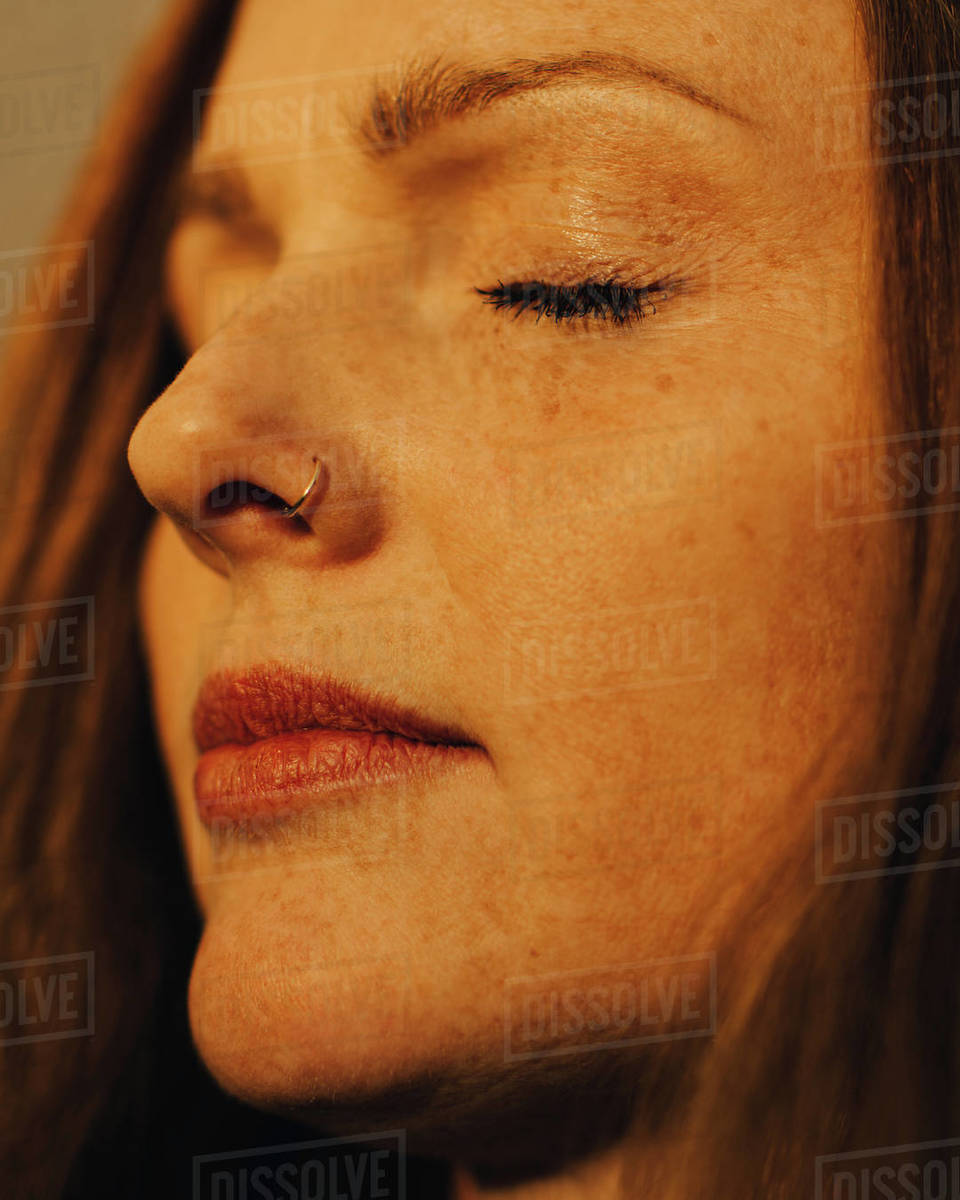 Closeup of woman with eyes closed in sunlight Stock Photo Dissolve