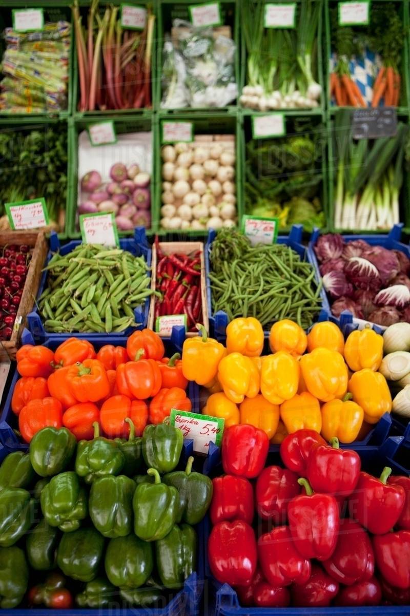 Various peppers shown on a market Stock Photo Dissolve