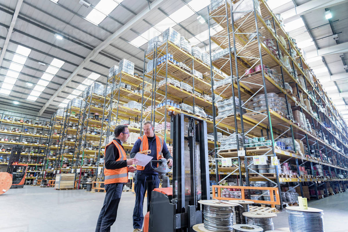 Workers in cable store warehouse at cable storage facility Stock Photo Dissolve