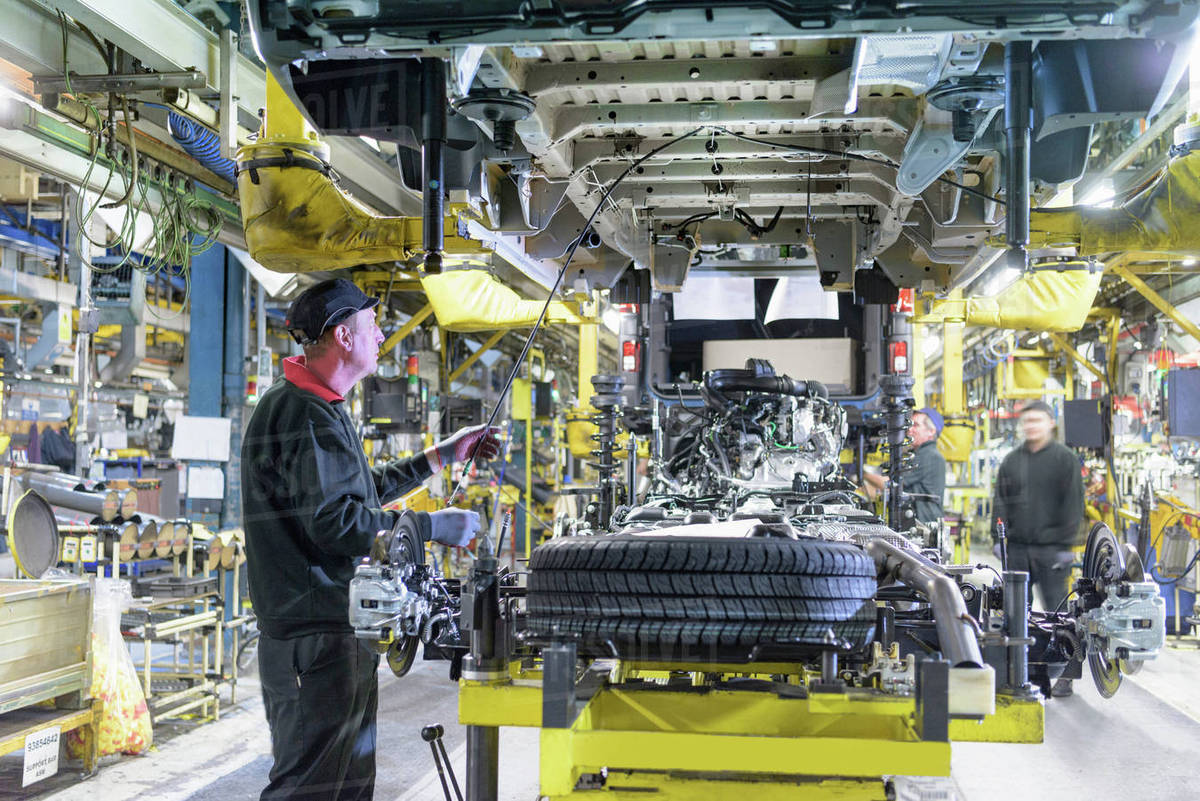 Workers on production line in car factory Stock Photo Dissolve