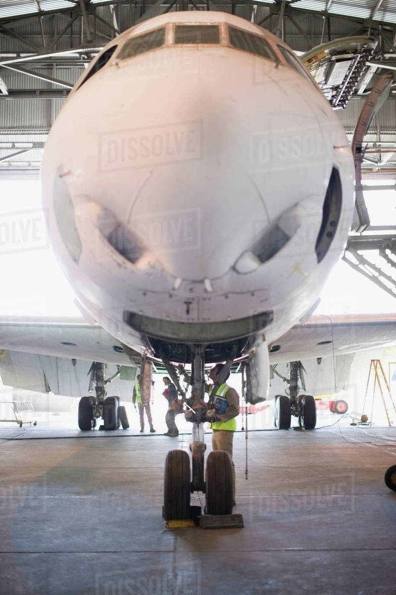 Aircraft worker checking airplane Royalty-free stock photo