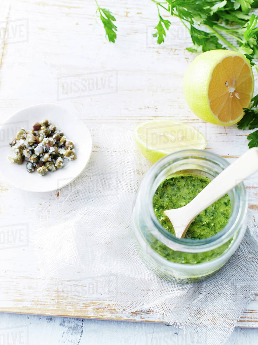 Salsa verde, capers, lemons Stock Photo Dissolve