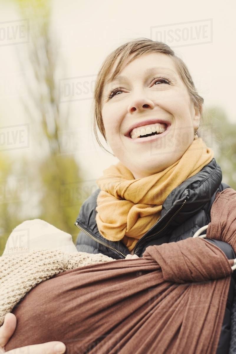 Portrait of mother carrying baby son Stock Photo Dissolve